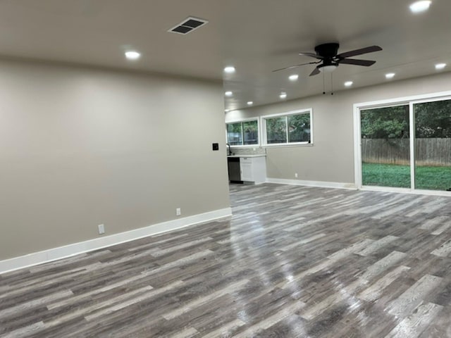 unfurnished living room with ceiling fan and hardwood / wood-style floors