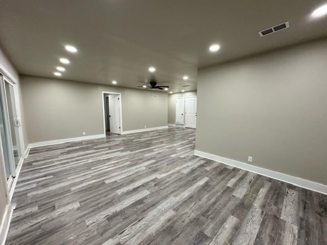 basement with ceiling fan and dark hardwood / wood-style floors