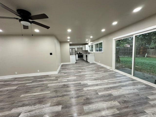 unfurnished living room featuring ceiling fan and light hardwood / wood-style floors