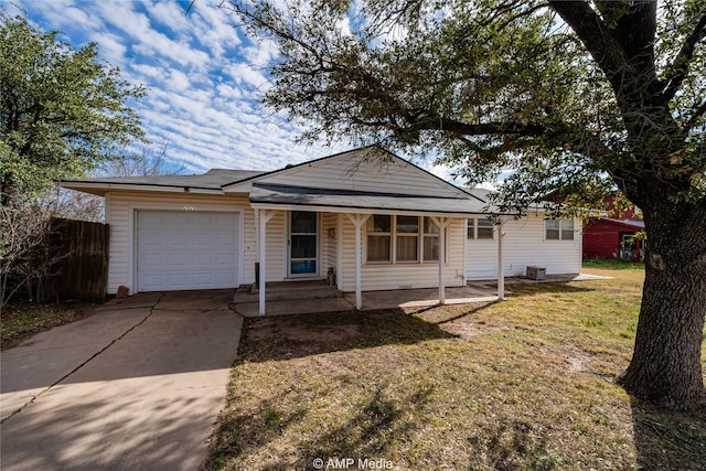 ranch-style house featuring a garage, a front yard, and covered porch