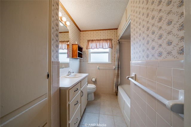 2025 Avenue Ave N, Anson, TX 79501 - bathroom featuring a textured ceiling, tile patterned flooring, vanity, tile walls, and toilet