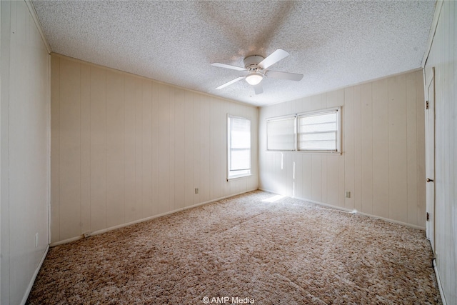 2025 Avenue Ave N, Anson, TX 79501 - carpeted empty room featuring ceiling fan, a textured ceiling, and wood walls