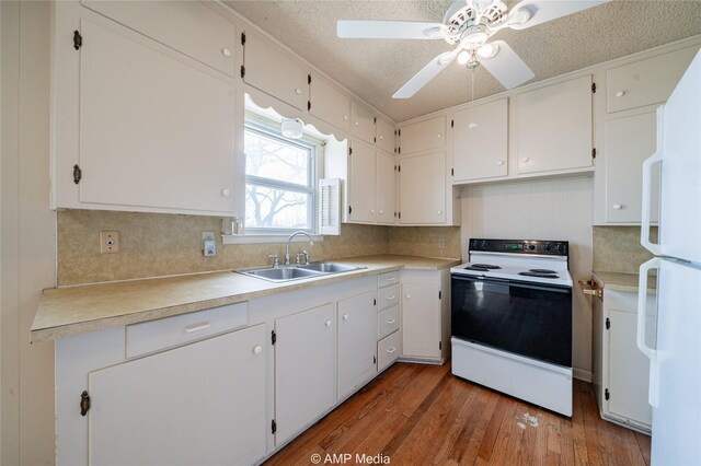 2025 Avenue Ave N, Anson, TX 79501 - kitchen with light wood-type flooring, white cabinetry, range with electric cooktop, and sink