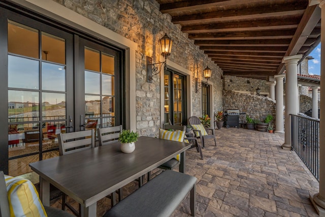 patio terrace at dusk featuring french doors and grilling area