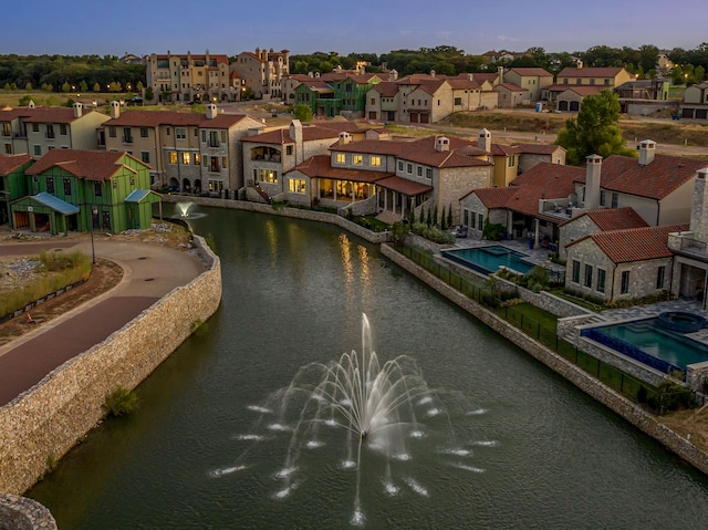 aerial view at dusk with a water view