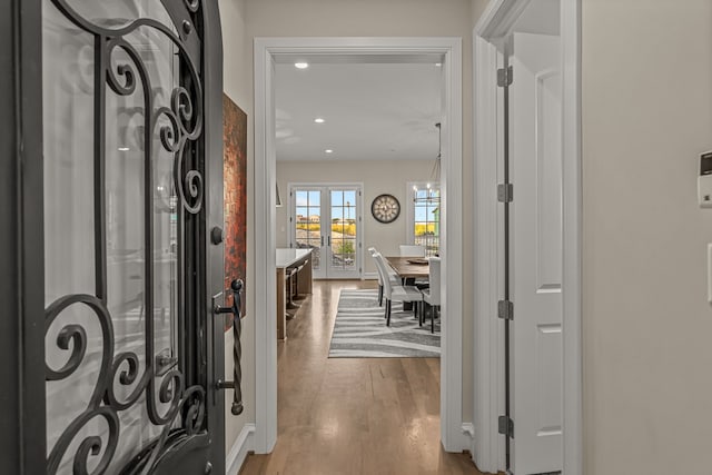 entrance foyer with french doors and hardwood / wood-style floors