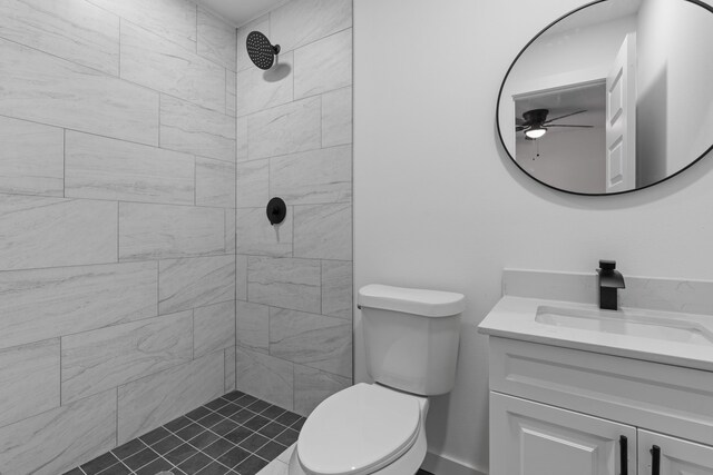 bathroom featuring tiled shower, vanity, and toilet