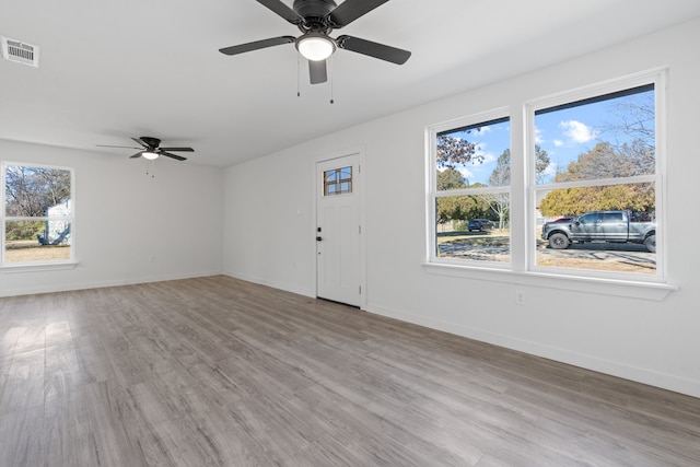 unfurnished living room with ceiling fan and light hardwood / wood-style floors