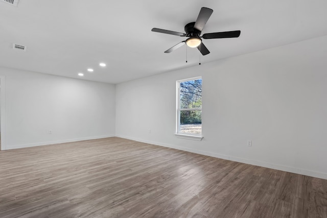 spare room with light hardwood / wood-style floors and ceiling fan