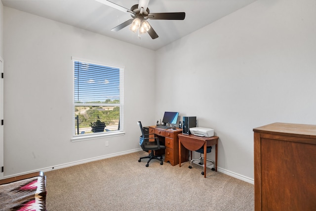 carpeted office space with ceiling fan