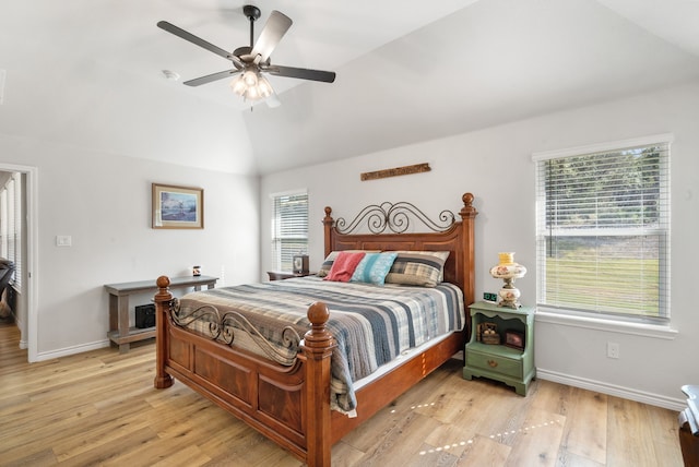 bedroom with ceiling fan, multiple windows, lofted ceiling, and light wood-type flooring