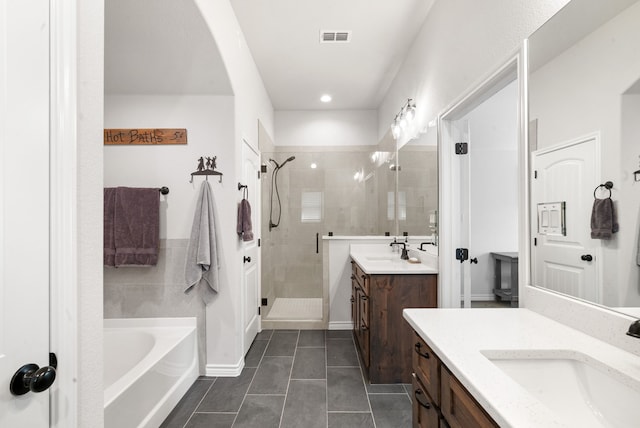 bathroom featuring tile patterned floors, vanity, and plus walk in shower