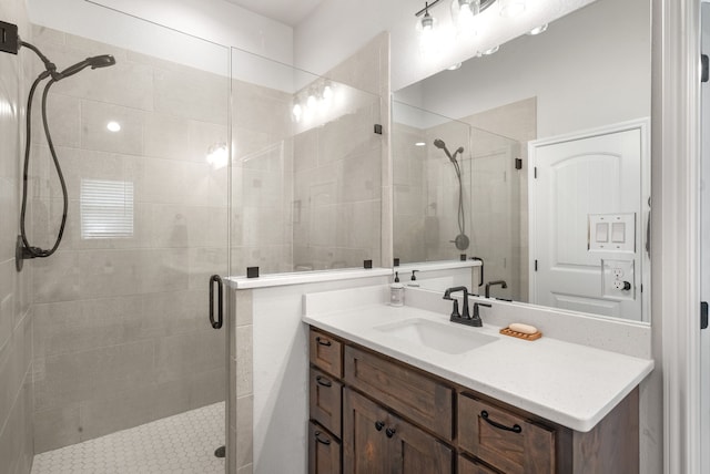 bathroom with a shower with door and vanity