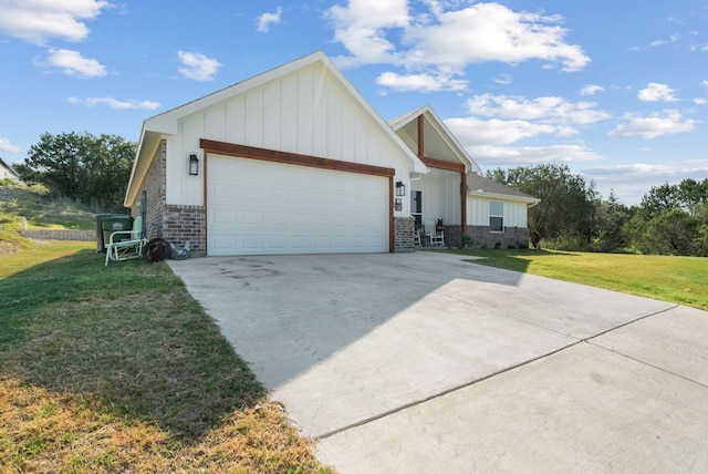 view of front of house with a front yard and a garage