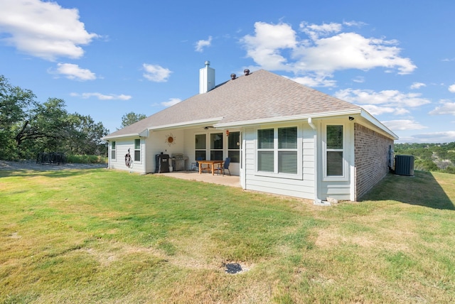 back of property with ceiling fan, central air condition unit, a patio area, and a yard