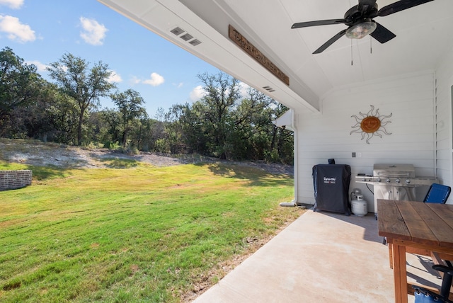 view of yard featuring ceiling fan and a patio area