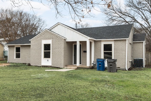 back of house with central AC and a yard