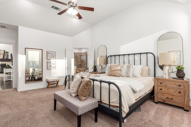 carpeted bedroom with ceiling fan and high vaulted ceiling