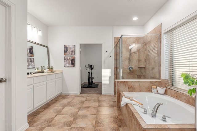 bathroom featuring vanity and plus walk in shower