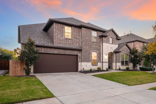 view of front of house with a lawn and a garage