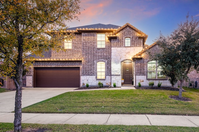 view of front of home featuring a garage and a lawn