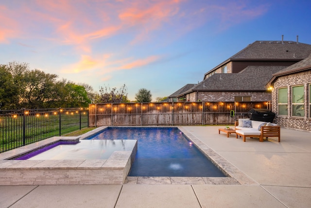 pool at dusk featuring pool water feature, area for grilling, an outdoor living space, and a patio