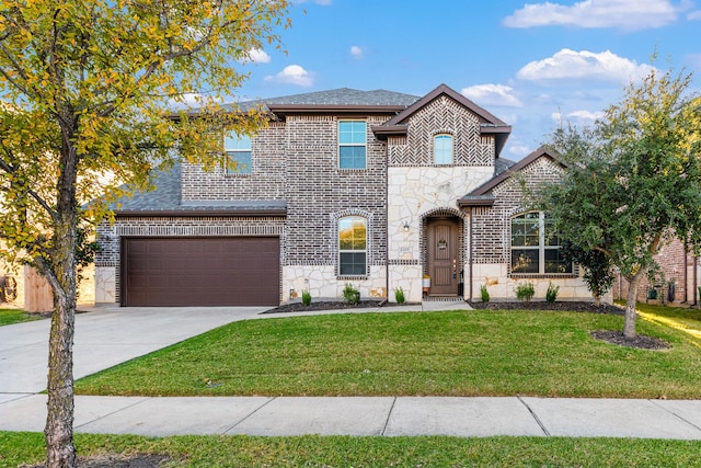 view of front of home with a garage and a front lawn