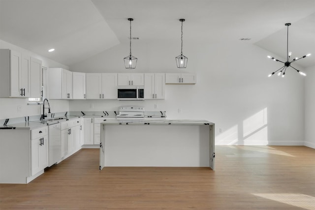 kitchen featuring white cabinets, sink, white appliances, and a center island