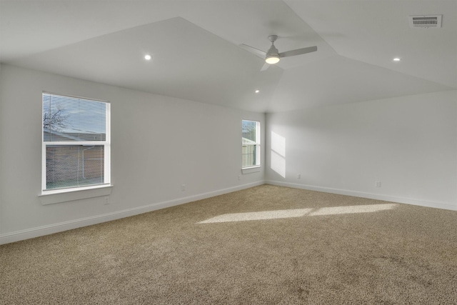 carpeted empty room featuring lofted ceiling and ceiling fan