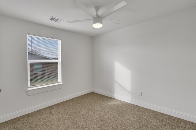 empty room with ceiling fan and carpet flooring