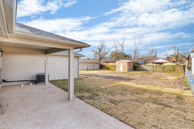 view of yard featuring a storage shed and a patio