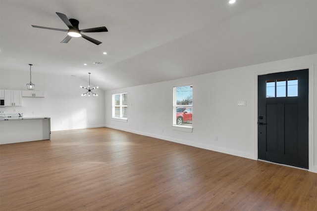 12069 Fm 1392, Terrell, TX 75160 - unfurnished living room featuring vaulted ceiling, light wood-style floors, a chandelier, baseboards, and a ceiling fan