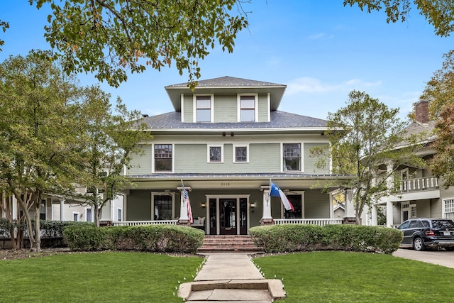 view of front facade featuring covered porch and a front lawn