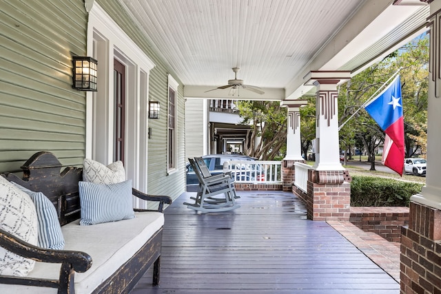 wooden deck featuring ceiling fan and a porch