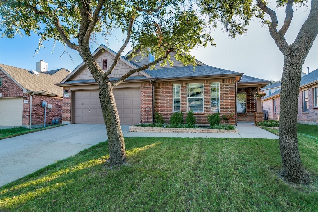 view of front of home with a front lawn and a garage