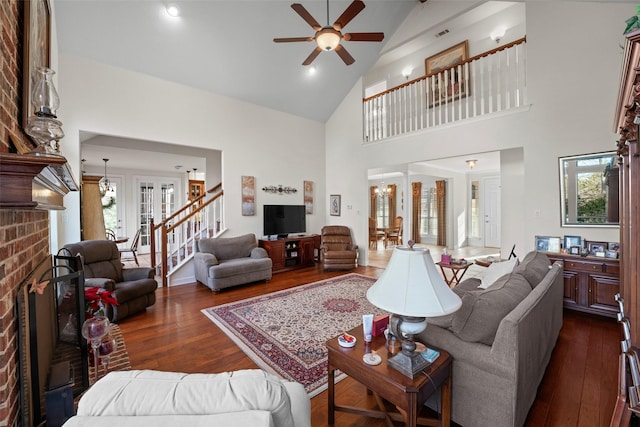 living room with high vaulted ceiling, dark wood-type flooring, ceiling fan, and a fireplace