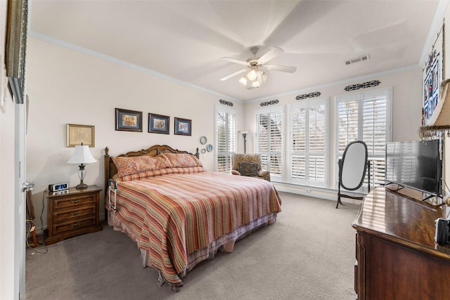 carpeted bedroom with ceiling fan and ornamental molding