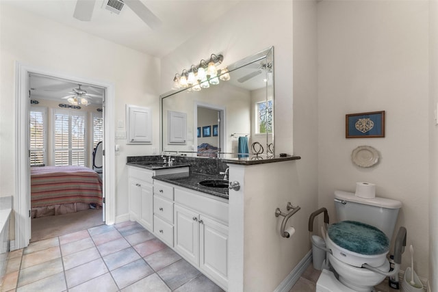 bathroom featuring toilet, ceiling fan, tile patterned flooring, and vanity