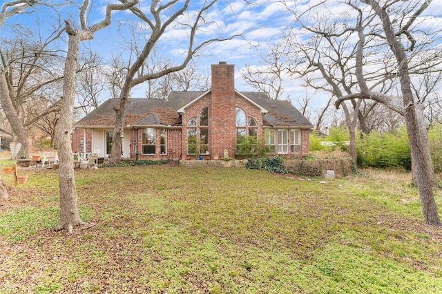 rear view of house with a lawn