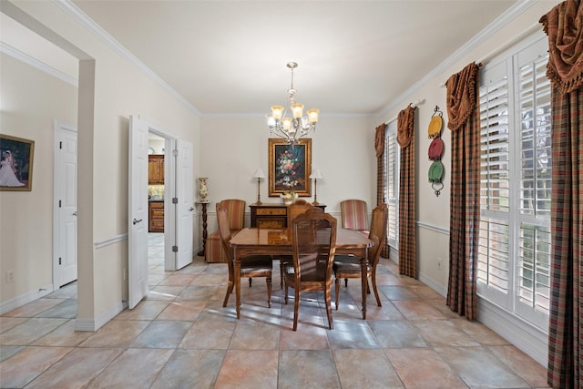 dining area with ornamental molding and a chandelier