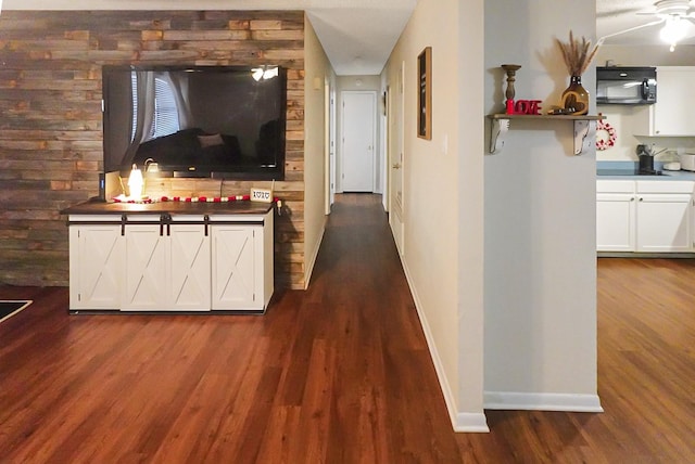 corridor featuring dark wood-type flooring