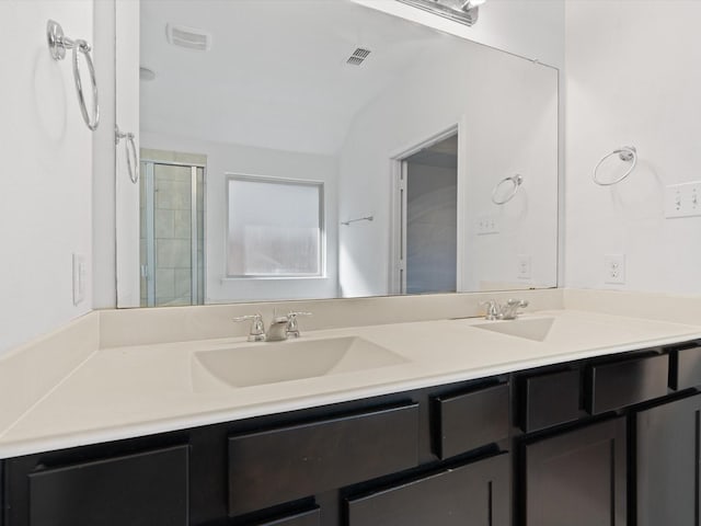 bathroom featuring walk in shower, vanity, and lofted ceiling