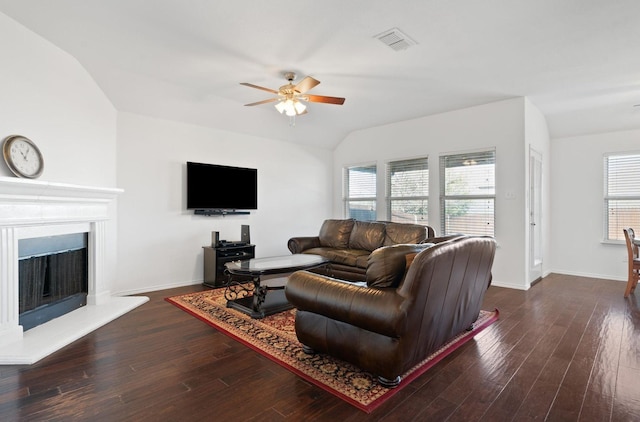 living room featuring ceiling fan, vaulted ceiling, and dark hardwood / wood-style flooring