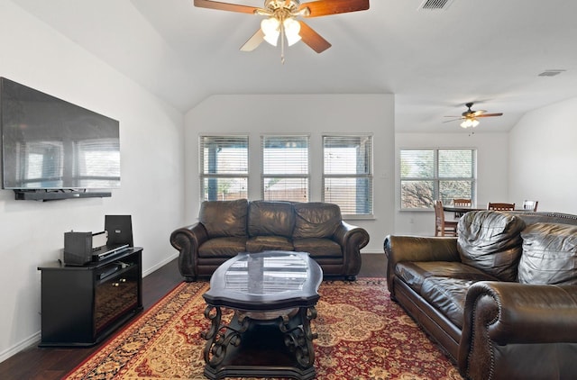 living room featuring ceiling fan, dark wood-type flooring, and lofted ceiling