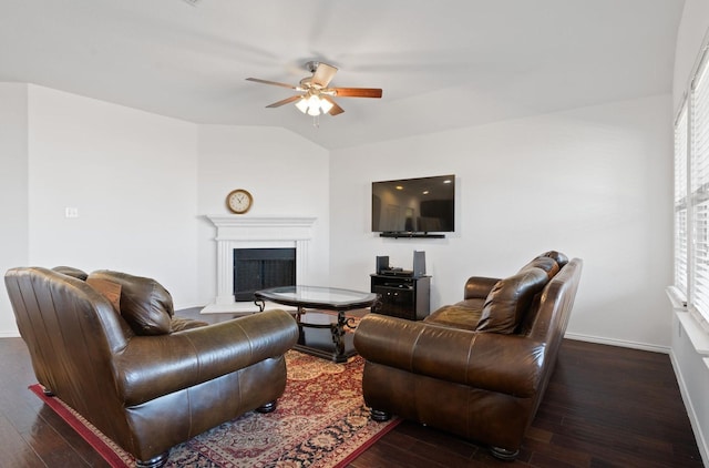 living room featuring ceiling fan, dark wood-type flooring, and vaulted ceiling