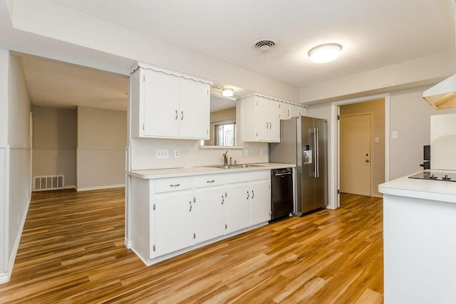 kitchen with white cabinetry, sink, light hardwood / wood-style floors, and black appliances