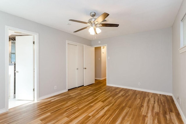 unfurnished bedroom featuring ceiling fan, a closet, and light hardwood / wood-style flooring