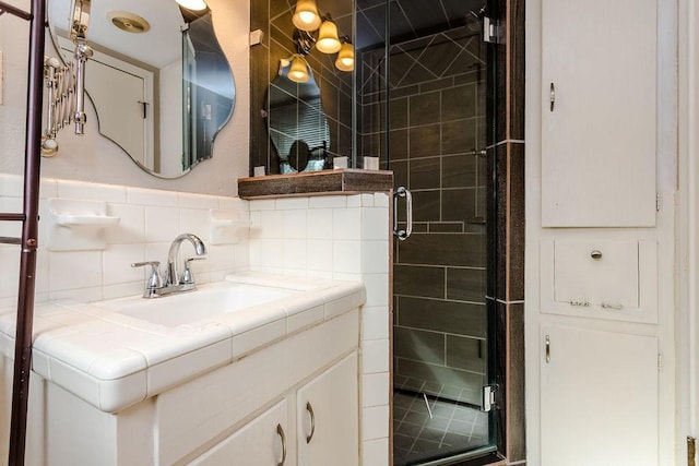 bathroom with backsplash, walk in shower, and vanity