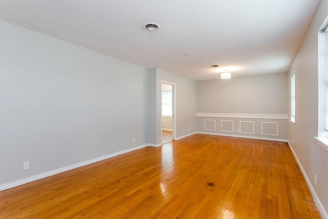 empty room with hardwood / wood-style flooring