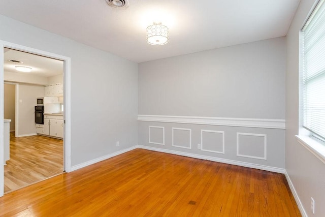 empty room with hardwood / wood-style flooring